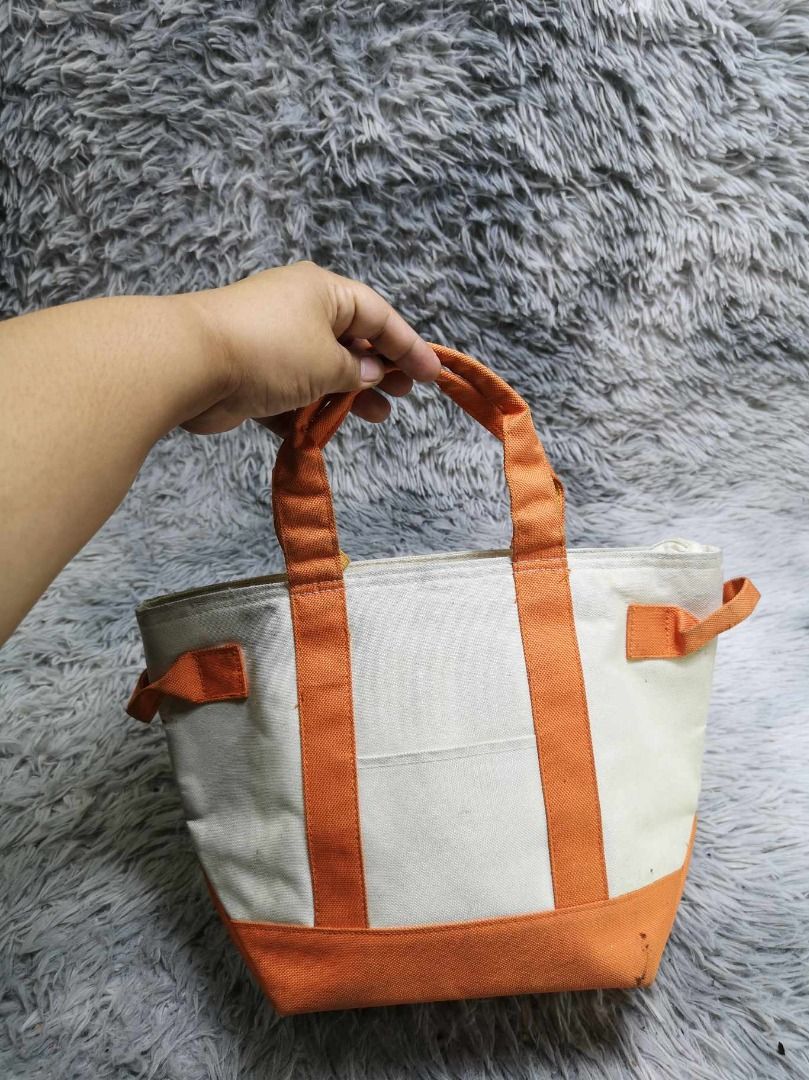 Off White Canvas With Orange Trim Tote Bag (Category: Tote Bags) located in Santa Cruz. Submitted by jmy_surplus.2 (Listing ID 1462705096, Image 3). Description: Size ; L - 9.2 W - 14 Color ; Off White Type ; Tote Bag Brand ; No brand Material ; Canvas Style ; Canvas Zipper Closure Tote Bag LR 129 JMY 5 Batch #222.