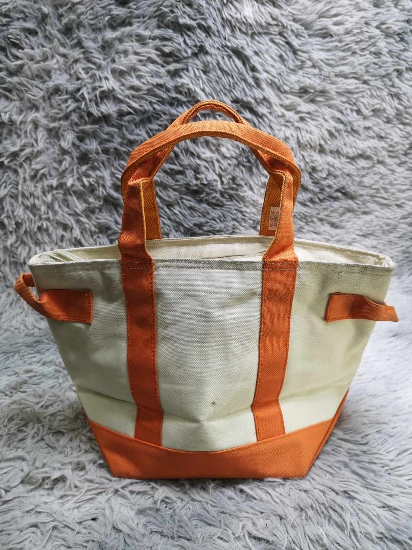 Off White Canvas With Orange Trim Tote Bag (Category: Tote Bags) located in Santa Cruz. Submitted by jmy_surplus.2 (Listing ID 1462705096, Image 1). Description: Size ; L - 9.2 W - 14 Color ; Off White Type ; Tote Bag Brand ; No brand Material ; Canvas Style ; Canvas Zipper Closure Tote Bag LR 129 JMY 5 Batch #222.