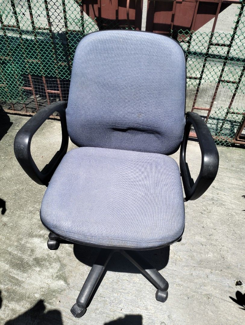 Ergonomic Office Chair (Category: Chairs) located in Bacoor. Submitted by biala17 (Listing ID 1462711305, Image 1). Description: -Grey fabric office chair -Mid-Back Support: A padded fabric backrest designed to support the lower and mid-spine area -Fixed Loop Armrests: Integrated curved plastic armrests attached to the seat and back. -Pneumatic Height Adjustment: A gas lift lever underneath the seat to change how high or low it sits. -Swivel Star