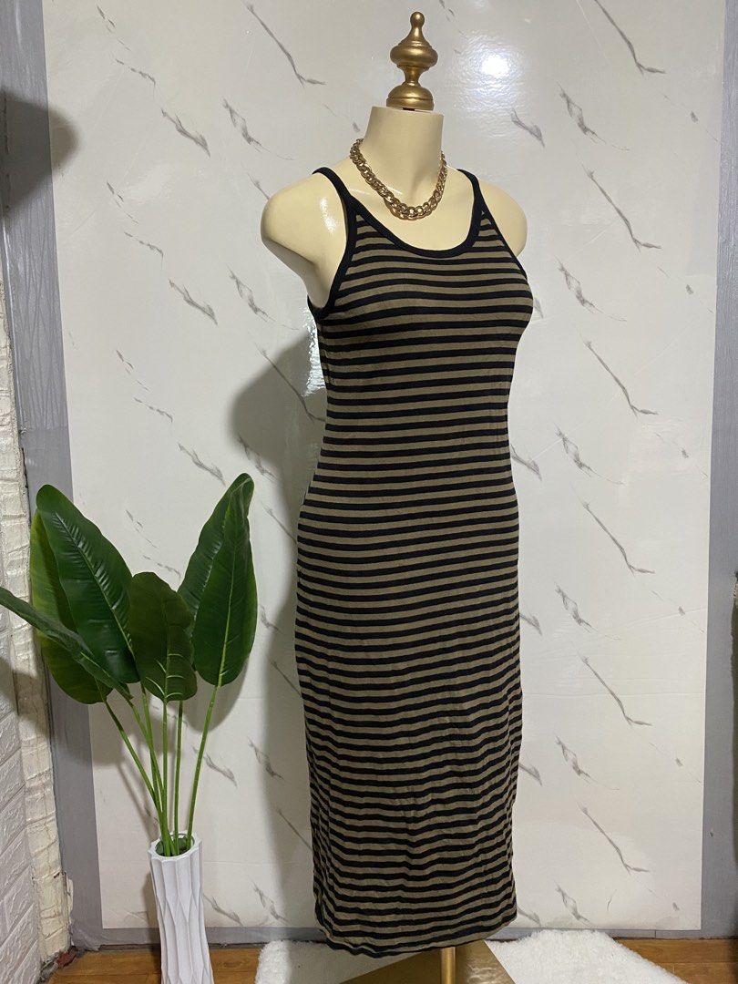 Old Navy Striped Midi Dress (Category: Dresses) located in Taguig. Submitted by dinoswear.ph (Listing ID 1462745774, Image 2). Description: - Brand: Old Navy - Style: Midi Dress - Color: Brown and Black Stripes - Features: Spaghetti straps, ribbed material - Length: Hits around the knee - Versatile: Easy to dress up or down, great for casual wear.