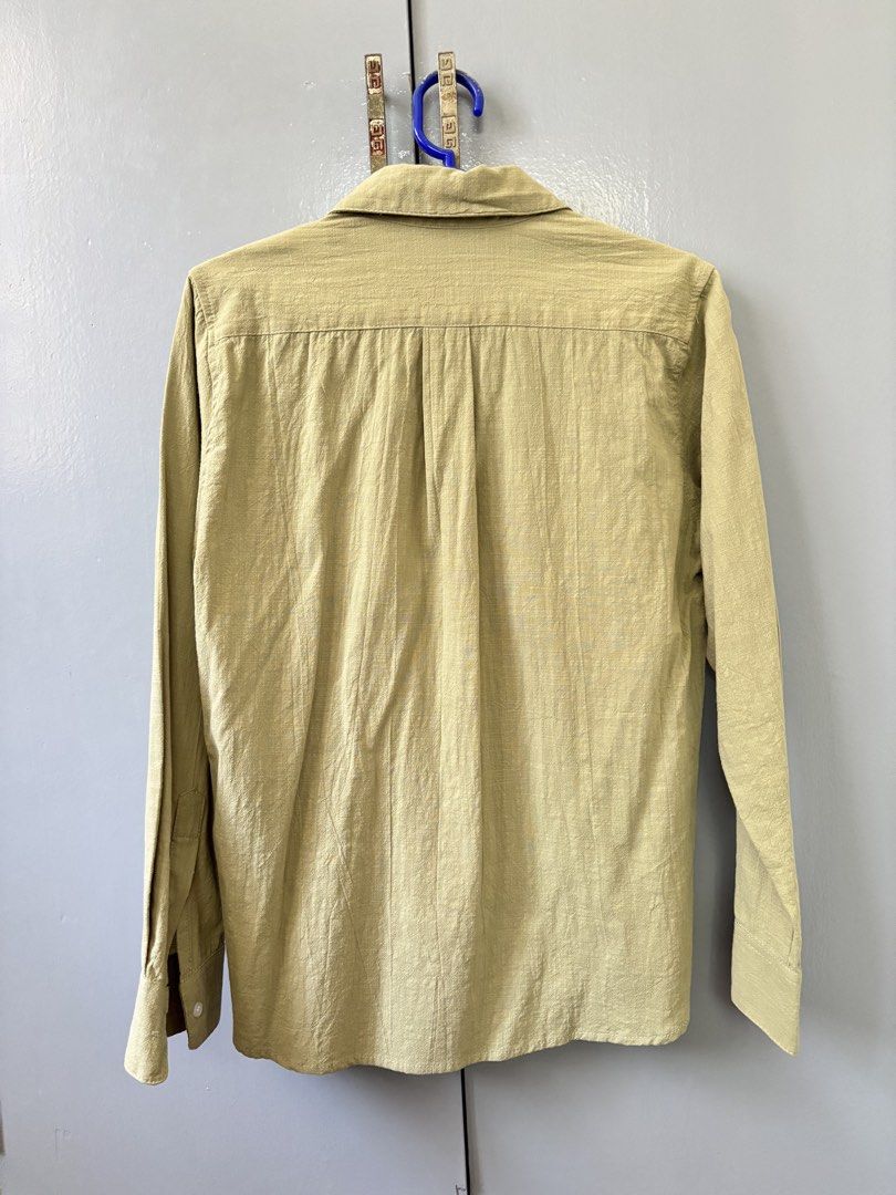 Olive Green Long Sleeve Button Up Shirt (Category: Community) located in Paranaque City. Submitted by ggg.bin (Listing ID 1462774864, Image 2). Description: - Olive green long sleeve shirt - Textured fabric - Button-up front with collar - Button cuffs with slit detail on sleeves - Estimated size: S - Ideal for casual outfits or layering.