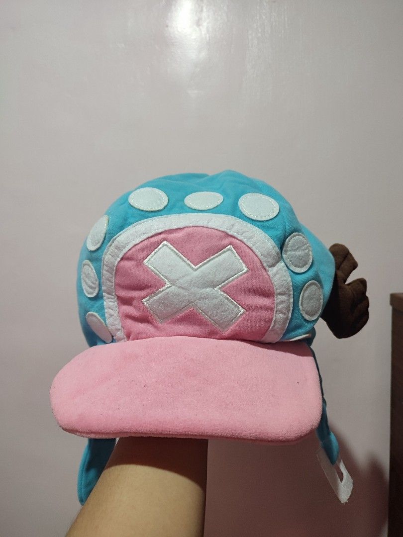 One Piece Chopper Hat Plush Cosplay (Category: Handmade Craft) located in Manila. Submitted by ailaarv (Listing ID 1462709925, Image 1). Description: COMIC ALLEY CHOPPER HAT 🥳 (user only once) - Super cute Chopper hat from One Piece - Made of soft plush material - Features iconic Chopper design with antlers and hat symbol - Ideal for cosplay or casual wear - Ear flaps provide warmth - Lined with pink fabric inside 📍 LAGUNA.
