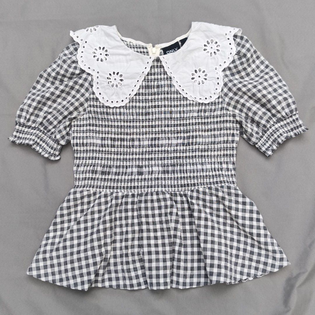 ONLY Black & White Gingham Smocked Top with Eyelet Collar (Category: Blouses) located in Alfonso Lista (Potia). Submitted by ak_collection.03 (Listing ID 1462802452, Image 1). Description: Elevate your wardrobe with this stylish Cottagecore / Coquette aesthetic peplum blouse from ONLY. Features a classic monochrome gingham plaid pattern, an elasticized smocked bodice for a flattering stretchy fit, and a dramatic statement white eyelet lace collar