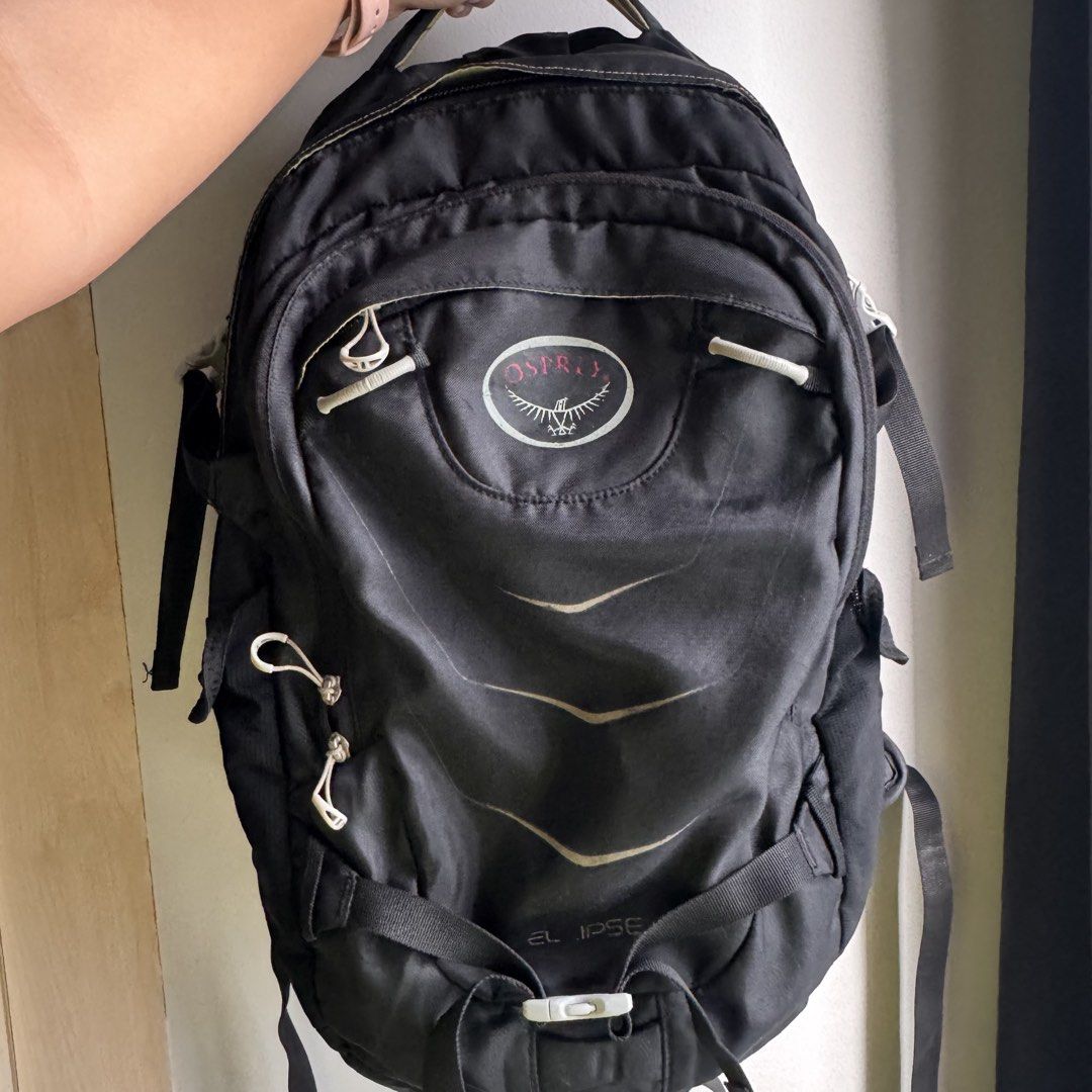 Osprey Ellipse Backpack Black (25L) (Category: Backpacks) located in Quezon City. Submitted by lyssa__ (Listing ID 1462726569, Image 1). Description: Black Osprey Ellipse Backpack (25L) - Multiple interior pockets - Stash and side pockets - Padded straps and back panel - Perfect for school, work, or hikes - With laptop compartment Condition: - Well used but functioning great - Minor flaws would be faded logo, loose side pocket, improvised one zip