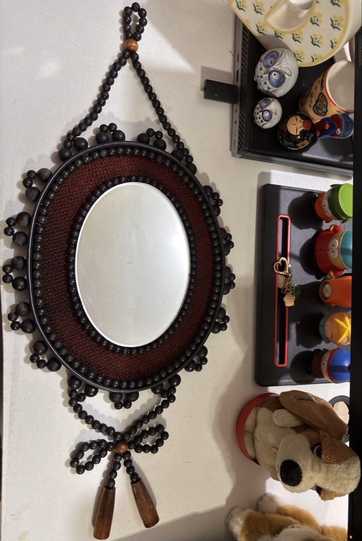 Oval Decorative Mirror with Beaded Frame (Category: Mirrors) located in Bacoor. Submitted by dangeusebio1515 (Listing ID 1462782644, Image 2). Description: - Unique oval mirror - Dark brown woven frame - Black bead accents - Beaded hanging loop - Two wooden tassels at the bottom - Perfect for a bohemian vibe - Approximately 10 inches .