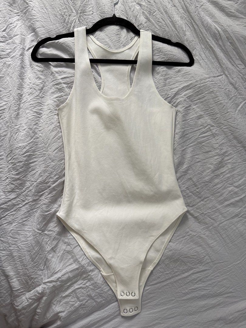 Patton White Racerback Bodysuit with Snap Closure (Category: Others Tops) located in Bacoor. Submitted by annmaliksi (Listing ID 1462757828, Image 1). Description: - Basic white racerback bodysuit - Stretchy material for a comfortable fit - Snap closure at the bottom for convenience - Versatile piece: great for layering or wearing on its own - Essential for any wardrobe Used once Orig price 3500.