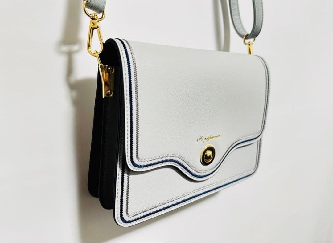 Pi. perfume Crossbody Bag (Category: Cross-body Bags) located in Quezon City. Submitted by garagesale2026 (Listing ID 1462868489, Image 2). Description: - Brand new with tag - Japan brand - Can be used as a clutch bag only; detachable shoulder strap - Gold-tone clasp and hardware; Flap closure; With navy and grey trim - Dimension: W24cm x H17cm x D7cm.