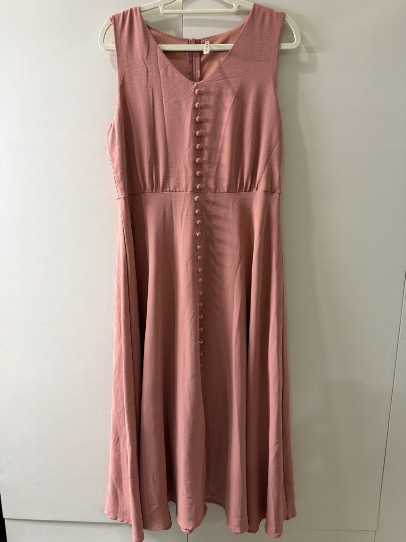 Pink Button Front Midi Dress (Category: Dresses) located in Rosario. Submitted by lovedtwiceph (Listing ID 1462799294, Image 1). Description: - Sleeveless pink midi dress - Flattering V-neck with button details - Comfortable elasticated waist - Flowy, flared skirt - Easy back zipper closure - Versatile: great for casual or dressed-up looks.