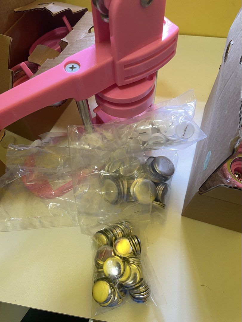 Pink Button Maker Machine with Button Parts (Category: Craft Supplies & Tools) located in Infanta. Submitted by frandez (Listing ID 1462755534, Image 2). Description: - Pink button maker machine - Includes various sizes of button parts (machine, molds, shells, pins) - Ideal for DIY projects and small businesses - Features easy-to-use lever action - All parts are in original packaging Still in good condition.