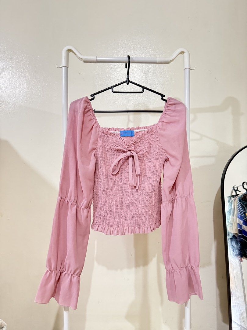 Pink Smocked Square Neck Puff Sleeve Top (Category: Blouses) located in Manila. Submitted by lovedbyan (Listing ID 1462879648, Image 1). Description: -₱100 -Genevieve Gozum - Adorable pink top with a trendy smocked bodice. - Features a flattering square neckline. - Stylish puff sleeves with flared cuffs. - Made from lightweight and flowy fabric for comfort. - Pairs beautifully with jeans or skirts..