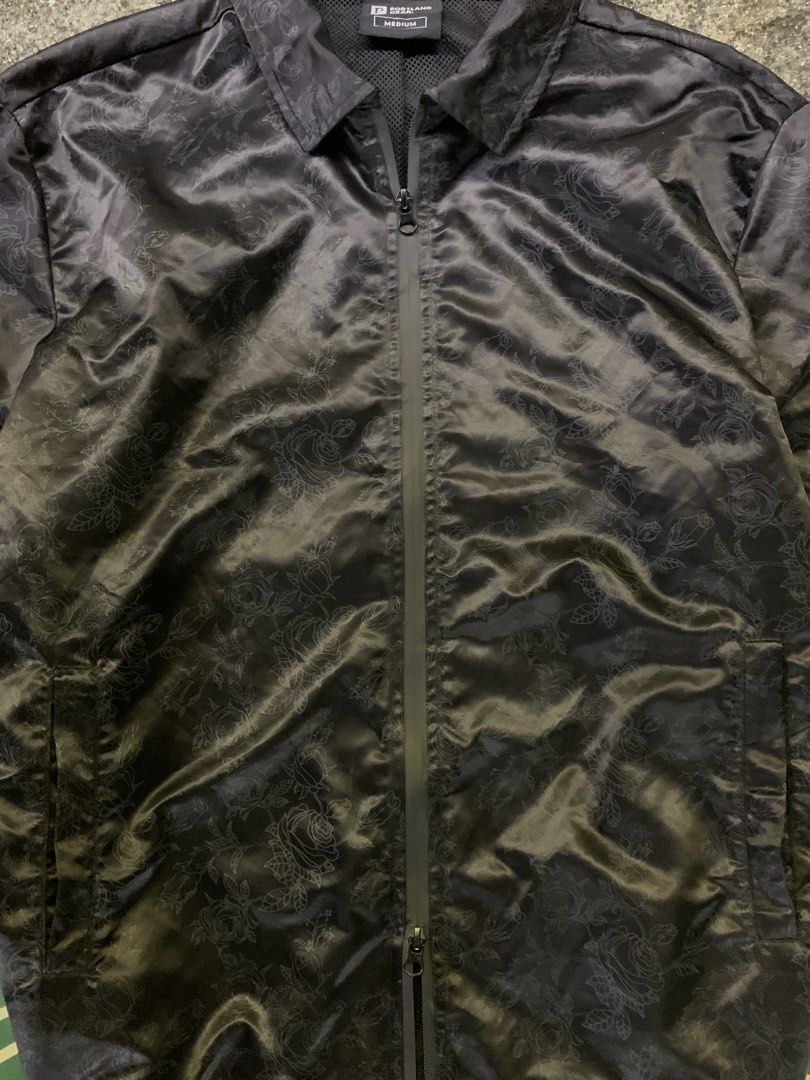 Portland Gear Black Rose Pattern Coach Jacket Medium (Category: Coats, Jackets and Outerwear) located in Manila. Submitted by thrift2mnla (Listing ID 1462812018, Image 2). Description: - Portland Gear black coach jacket - Subtle all-over rose pattern - Full zip closure - Front pockets - Ribbed cuffs with green and white stripes - 'P' logo on left sleeve - Ideal for layering.