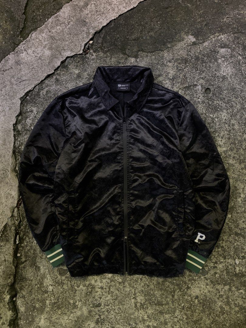 Portland Gear Black Rose Pattern Coach Jacket Medium (Category: Coats, Jackets and Outerwear) located in Manila. Submitted by thrift2mnla (Listing ID 1462812018, Image 1). Description: - Portland Gear black coach jacket - Subtle all-over rose pattern - Full zip closure - Front pockets - Ribbed cuffs with green and white stripes - 'P' logo on left sleeve - Ideal for layering.