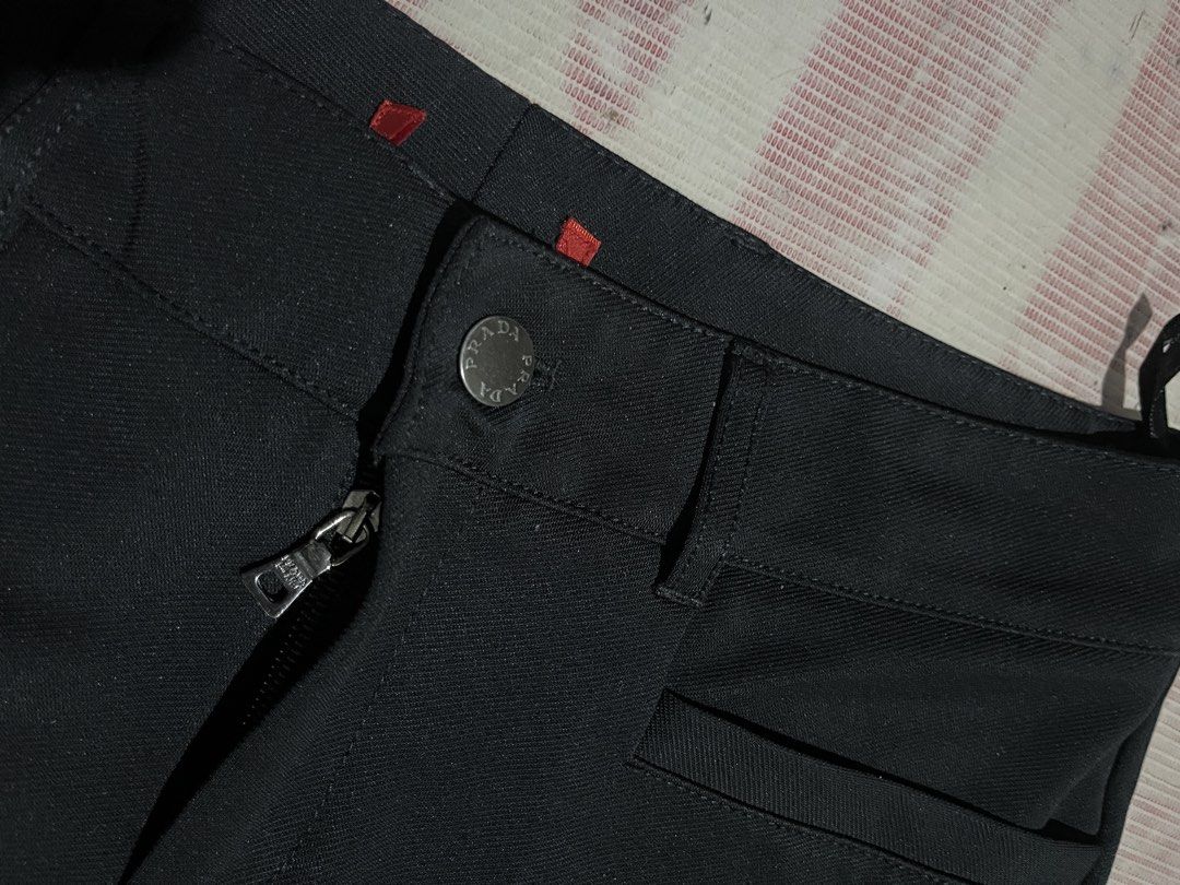 Prada Black Pants (Category: Other Bottoms) located in Manila. Submitted by na2oy777 (Listing ID 1462685667, Image 3). Description: - Authentic Black Prada Pants - Secure button and zip closure - Distinctive red square details on waistband - Convenient inner pockets - Perfect for both casual and formal styling.