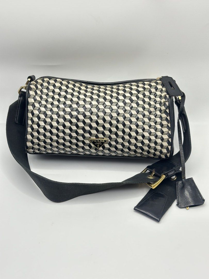 Prada Geometric Cube Pattern Cylinder Bag with Lock and Key (Category: Luxury Bags & Wallets) located in Manila. Submitted by dough_lux (Listing ID 1462685025, Image 1). Description: - Authentic Prada cylinder bag - Unique geometric cube pattern - Black leather trim and strap - Gold hardware - Comes with original lock and key - Versatile for everyday or evening use.