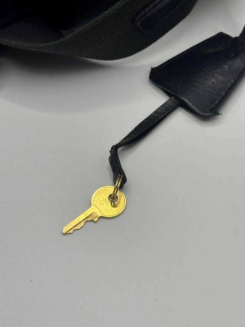 Prada Geometric Cube Pattern Cylinder Bag with Lock and Key (Category: Luxury Bags & Wallets) located in Manila. Submitted by dough_lux (Listing ID 1462685025, Image 2). Description: - Authentic Prada cylinder bag - Unique geometric cube pattern - Black leather trim and strap - Gold hardware - Comes with original lock and key - Versatile for everyday or evening use.