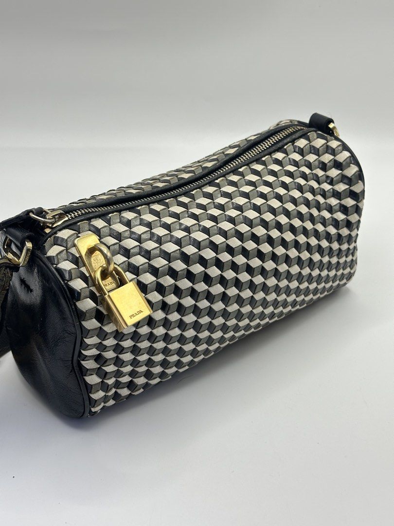 Prada Geometric Cube Pattern Cylinder Bag with Lock and Key (Category: Luxury Bags & Wallets) located in Manila. Submitted by dough_lux (Listing ID 1462685025, Image 3). Description: - Authentic Prada cylinder bag - Unique geometric cube pattern - Black leather trim and strap - Gold hardware - Comes with original lock and key - Versatile for everyday or evening use.