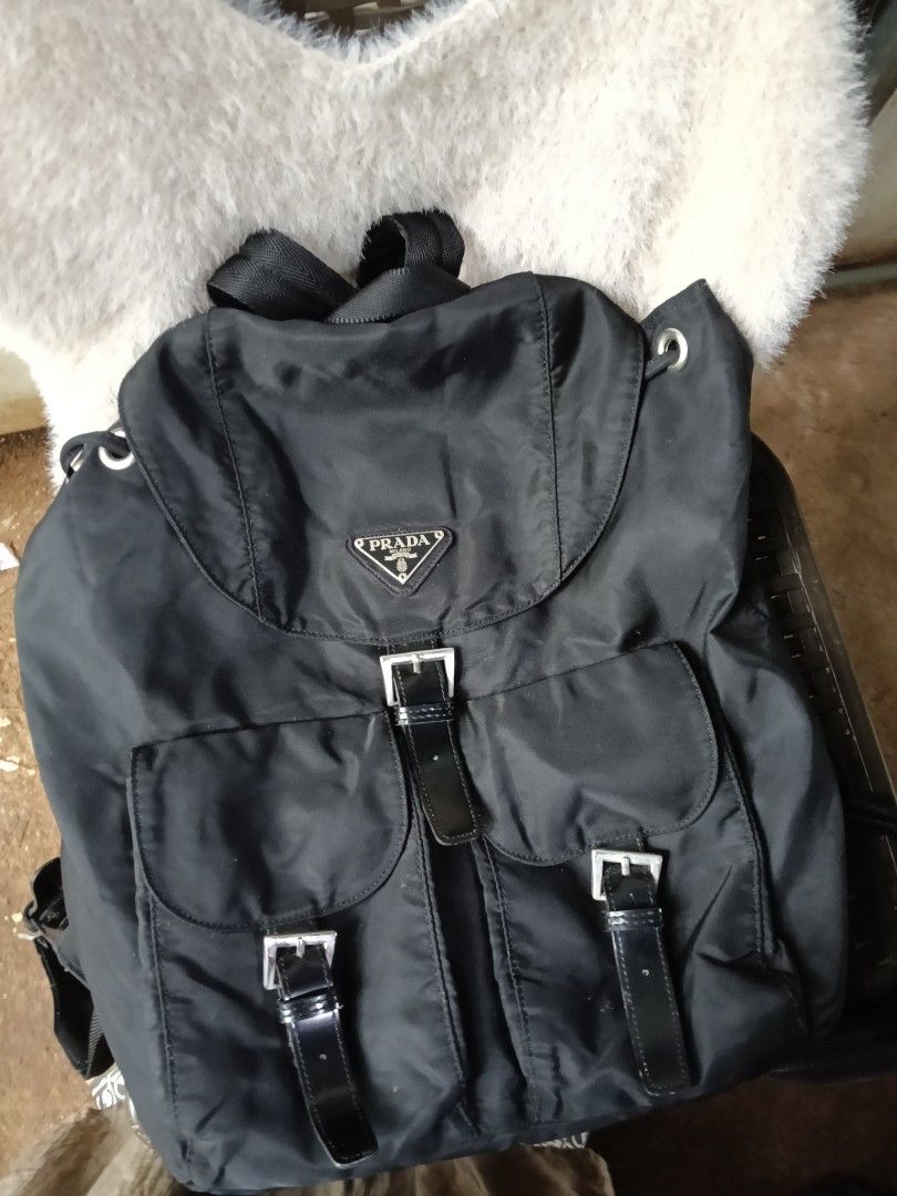 Prada Nylon Backpack Black (Category: Luxury Bags & Wallets) located in Antipolo. Submitted by vastgem_4c8da8 (Listing ID 1462884970, Image 1). Description: - Classic Prada backpack in black nylon - Iconic Prada triangle logo - Multiple front pockets with buckle closures - Drawstring and buckle flap closure - Interior zippered pocket - Great for everyday use or travel not sure kung OG .