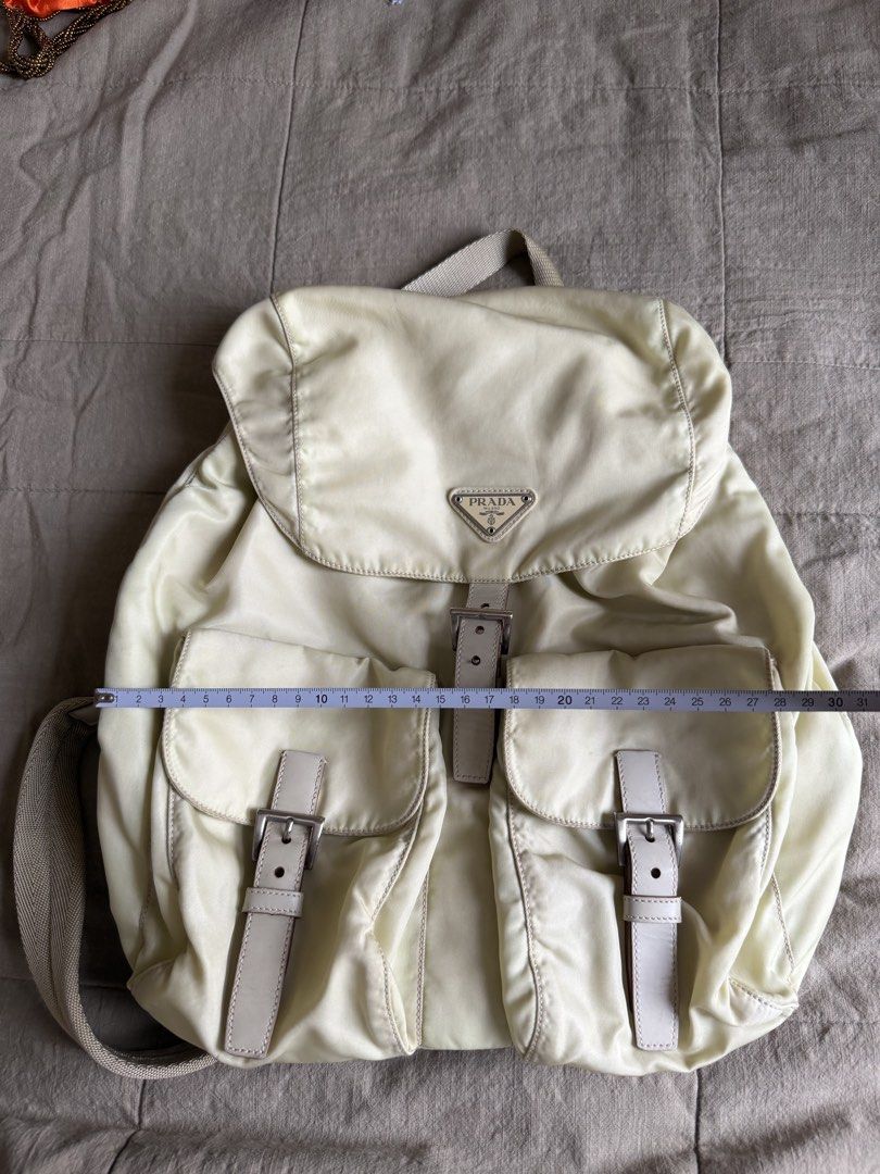 Prada Re-edition Nylon Backpack Beige (Category: Luxury Bags & Wallets) located in Davao. Submitted by lyscapuno (Listing ID 1462686181, Image 3). Description: FREE backpack organizer - Classic Prada backpack - Beige nylon material - Two front pockets with buckle closures - Adjustable shoulder straps - Top handle - Iconic Prada logo on the front - Great for everyday use RFS: Not being used - pricr slightly negotiable.