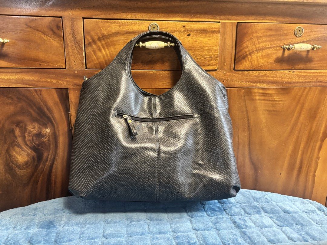 Preloved Anne Klein Leather Hobo Bag (Category: Shoulder Bags) located in Imus. Submitted by bagsofblessings24 (Listing ID 1462744110, Image 3). Description: Original Preloved Anne Klein Black Embossed Leather Hobo Shoulder Bag Stylish black hobo bag - Subtle snakeskin embossed texture - Elegant gold-tone hardware - Secure top zipper closure - Multiple interior compartments and a zippered pocket - Ideal for everyday use Minimal hairlines in the l