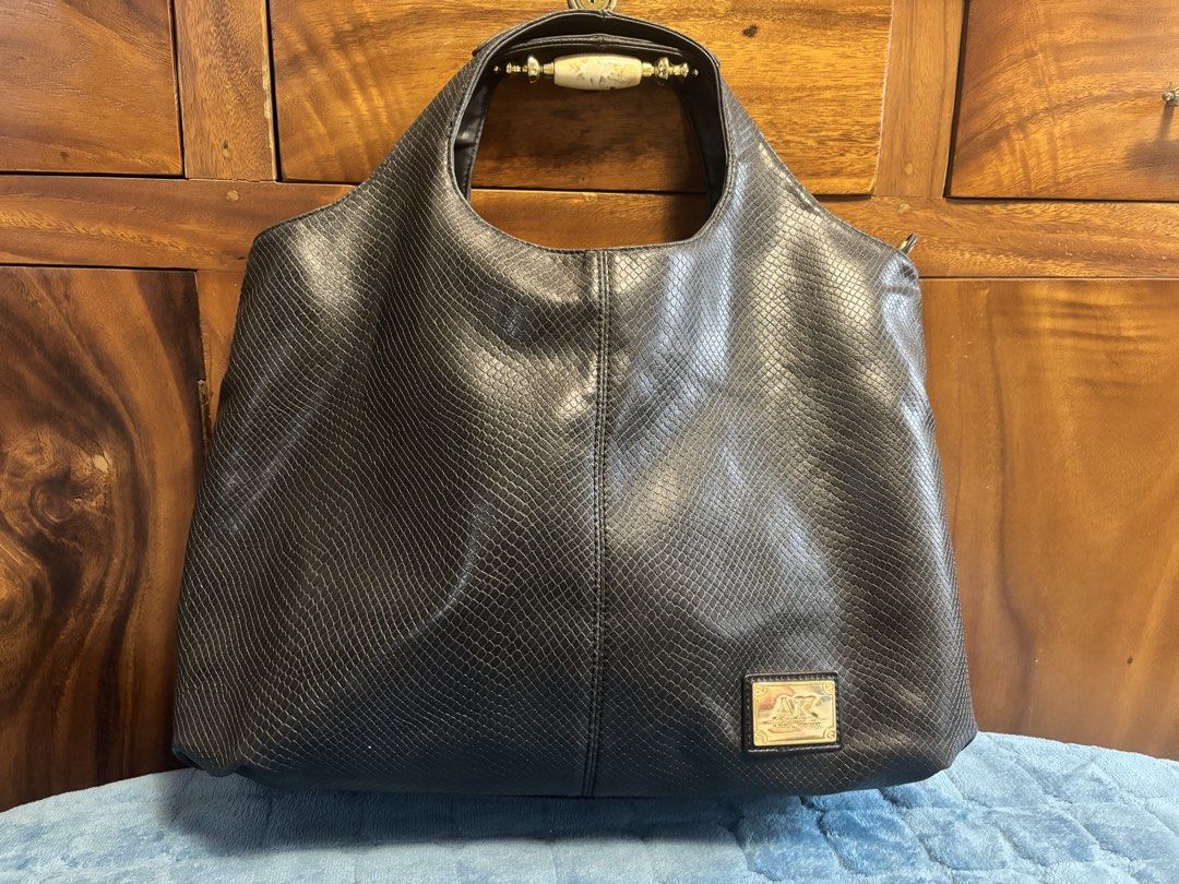 Preloved Anne Klein Leather Hobo Bag (Category: Shoulder Bags) located in Imus. Submitted by bagsofblessings24 (Listing ID 1462744110, Image 2). Description: Original Preloved Anne Klein Black Embossed Leather Hobo Shoulder Bag Stylish black hobo bag - Subtle snakeskin embossed texture - Elegant gold-tone hardware - Secure top zipper closure - Multiple interior compartments and a zippered pocket - Ideal for everyday use Minimal hairlines in the l