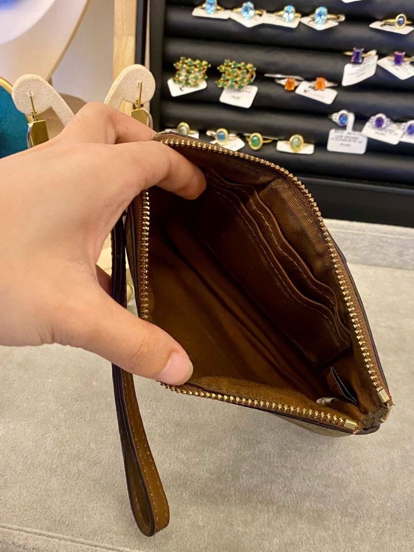 PRELOVED ORIGINAL COACH WRISTLET (Category: Wallets & Card holders) located in Baguio. Submitted by asna_taku (Listing ID 1462806335, Image 2). Description: PRELOVED ORIGINAL CO@ĆH WRISTLET 🤎 A classic C0açh wristlet featuring the signature monogram canvas with a tan/brown striped design and leather detailing. Timeless, understated, and easy to pair with any outfit—perfect for everyday use or a polished casual look. ✨ Original C0@ch 🤎 Tan/Brown