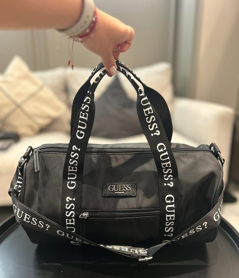 Preorder Guess Black Duffle Bag with Logo Strap (Category: Cross-body Bags) located in Quezon City. Submitted by coramalabanan (Listing ID 1462844761, Image 2). Description: - Preorder - 50% down payment - 50% pagdating dito pinas - Authentic Guess duffle bag - All-over Guess logo on straps - Spacious main compartment - Convenient front zip pocket - Ideal for gym sessions or weekend trips - Easily fits all your essentials.