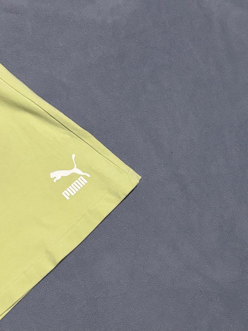 Puma High Waisted Ribbed Shorts (Category: Shorts) located in Miagao. Submitted by juliusokra (Listing ID 1462853963, Image 2). Description: - Brand: Puma - Color: Bright Lime Green - Style: High-waisted shorts - Features: Ribbed waistband, comfortable and stretchy material - Ideal for: Workouts or casual wear - Fit: Waistline fits 24"-28" - Length: 14.5 inches.