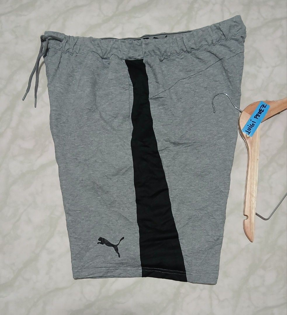 Puma Men's Grey Athletic Shorts XL (Category: Shorts) located in Plaridel. Submitted by igieperez147282 (Listing ID 1462843795, Image 2). Description: - Grey Puma shorts - Black side stripes - Elastic waistband with drawstring - Size XL (fits waist 36-42 inches) - Length: 20 inches - Made in Cambodia - Ideal for casual wear or sports.