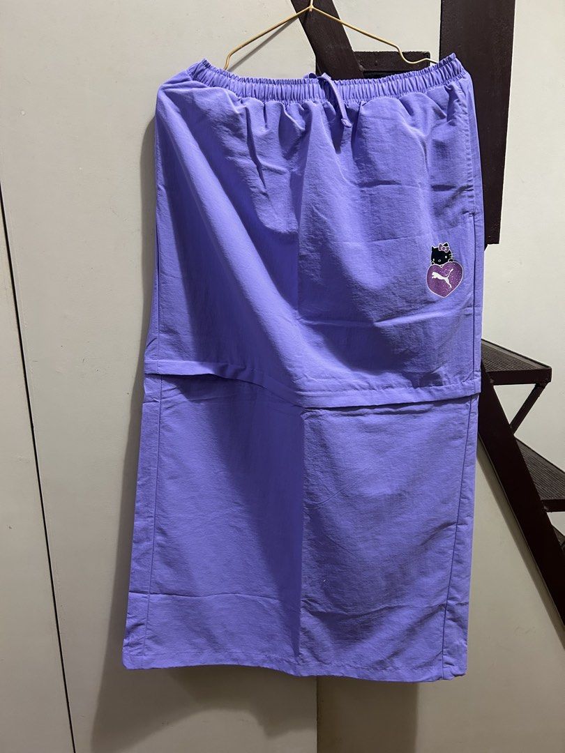 Puma x Hello Kitty Purple Skirt (Category: Skirts) located in Muntinlupa City. Submitted by pearlsarchives (Listing ID 1462837072, Image 3). Description: - Collaboration: Puma x Kitty - Color: Purple - Style: Midi skirt - Features: Elastic waistband with drawstring, back slit - Versatile: Great for casual or sporty looks - Design: Super cute!.