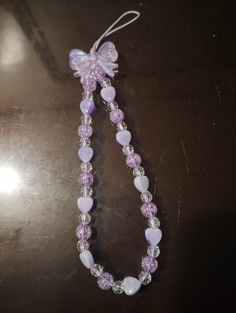 Purple Beaded Charm with Bow (Category: Charms) located in San Jose del Monte. Submitted by pinkpenguin.2005ya (Listing ID 1462823941, Image 1). Description: - Adorable purple beaded charm - Features a sparkly bow - Decorated with heart-shaped beads - Includes clear accent beads - Has a loop for easy attachment to bags or phones - Ideal for kawaii or Y2K aesthetic - Fun and playful accessory.