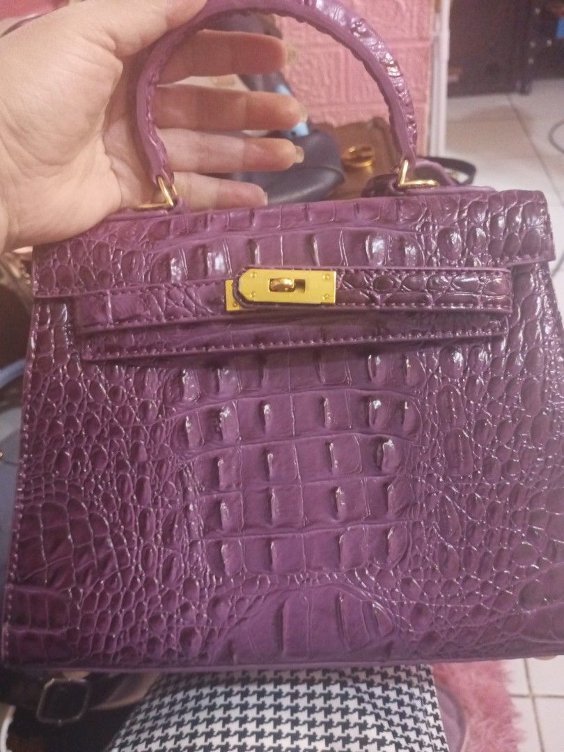 Purple Crocodile Embossed Top Handle Bag (Category: Luxury Bags & Wallets) located in Manila. Submitted by maritanaai22557 (Listing ID 1462769072, Image 1). Description: - Stylish purple handbag - Crocodile embossed texture - Elegant gold hardware closure - Convenient top handle - Structured design - Includes a small hanging tag.