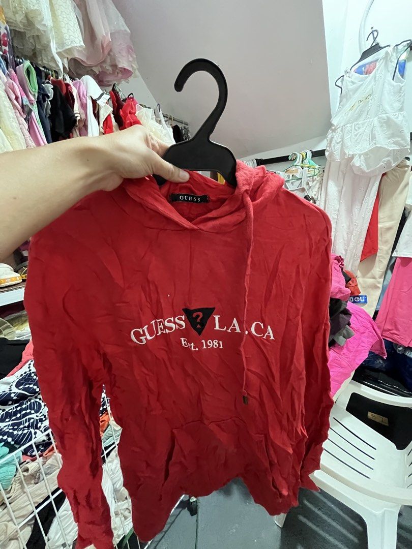 Red Guess la.ca Est. 1981 Hoodie (Category: Hoodies) located in Quezon City. Submitted by casabalerica (Listing ID 1462795144, Image 1). Description: - Red Guess hoodie - Features 'LA.CA Est. 1981' graphic - Long sleeves - Front pocket - Drawstring hood - Ideal for casual wear.