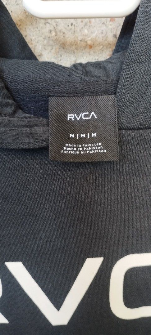 RVCA Black Hoodie (Category: Coats, Jackets and Outerwear) located in Manila. Submitted by beckster_nnline_luxuryshop (Listing ID 1462870709, Image 3). Description: - Black RVCA hoodie - Size: Medium (M) - White RVCA logo on the front - Small VA logo detail near the hem - Convenient kangaroo pocket - Adjustable drawstring hood - Made in Pakistan.