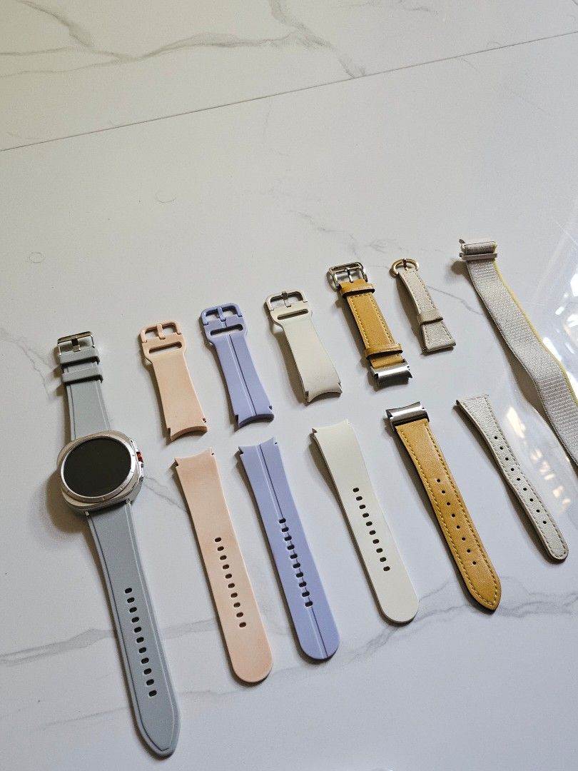 Samsung Galaxy Watch6 (Category: Wearables & Smart Watches) located in Vigan. Submitted by kortnidru (Listing ID 1462765571, Image 2). Description: - Samsung Galaxy Watch6 (Model: SM-R930) - Comes with attached grey silicone band - Additional watch bands included: white, yellow, light purple, peach - Includes 2 charging cable and wireless charger - Screen protectors and cleaning wipes provided.