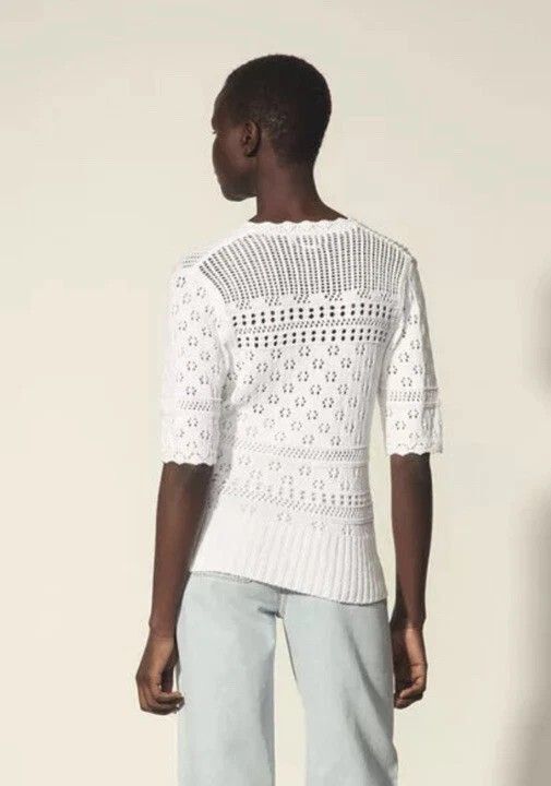 SANDRO PARIS KNITTED (Category: Blouses) located in Dasmarinas. Submitted by oneofakind_98 (Listing ID 1462865302, Image 2). Description: SANDRO PARIS This is a white short-sleeved pointelle-knit sweater by Sandro featuring an open-knit floral pattern and a scalloped V-neckline. - Strechy Measurement when Iaid flat Size 1 on tag 17 inches armpit to armpit 24 inches length 15.5 inches shoulder to shoulder 15.5 inches chest 12 inches short sleeve 1