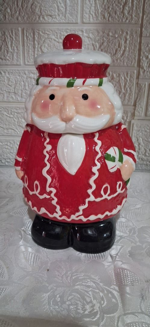 Santa Claus Ceramic Cookie Jar with Lid (Category: Other Home Decor) located in Manila. Submitted by katkween23 (Listing ID 1462734013, Image 1). Description: - Adorable Santa Claus ceramic cookie jar - Ideal for storing cookies and holiday treats - Snug-fitting lid to keep contents fresh - Charming Christmas decor piece - Features hand-painted details - Measures approximately [insert height here] inches tall - A delightful addition to your kitch