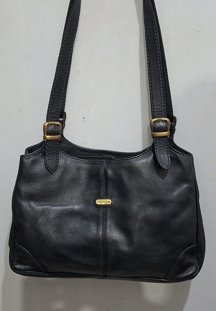Satchi Club Black Leather Shoulder Bag (Category: Shoulder Bags) located in Quezon City. Submitted by moonthrifting (Listing ID 1462710355, Image 1). Description: - Brand: Satchi Club - Material: Genuine Leather - Color: Black - Closure: Magnetic snap - Interior: 1 zippered pocket - Hardware: Gold tone - Straps: Adjustable buckles - Style: Classic, perfect for everyday use.