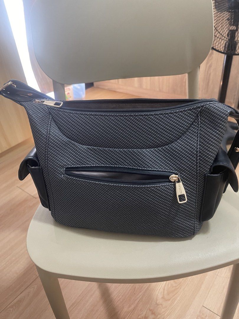 SECOSANA Grey Textured Crossbody Bag with Side Pockets (Category: Cross-body Bags) located in Manila. Submitted by jvlni (Listing ID 1462689042, Image 3). Description: - SECOSMA grey textured crossbody bag - Main zip compartment - Front zip pocket - Two side pockets for extra storage - Adjustable strap - Gold hardware details - Ideal for everyday use.