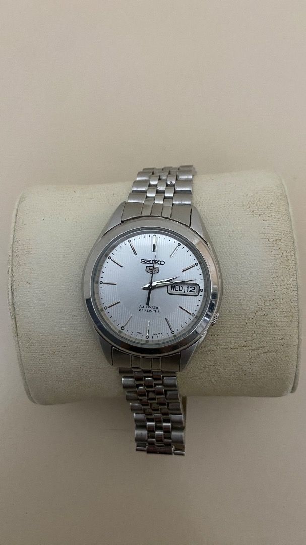 Seiko 5 Automatic Watch with Extra Straps (Category: Accessory Holder, Box & Organizers) located in Pasig City. Submitted by truewolf-30e0 (Listing ID 1462875421, Image 1). Description: - Seiko 5 Automatic Watch - Classic silver dial - Day and date function - Includes original seiko metal bracelet - Comes with two additional black leather straps - In good working condition - Ideal for everyday wear.