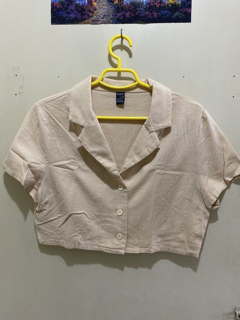 SHEIN Beige Cropped Collared Shirt XL (Category: Shirts) located in Pasig City. Submitted by alaineeeee (Listing ID 1462770755, Image 1). Description: - Beige cropped shirt from SHEIN - Features a collared neckline and button-up front - Short sleeves - Size XL - Ideal for casual wear.