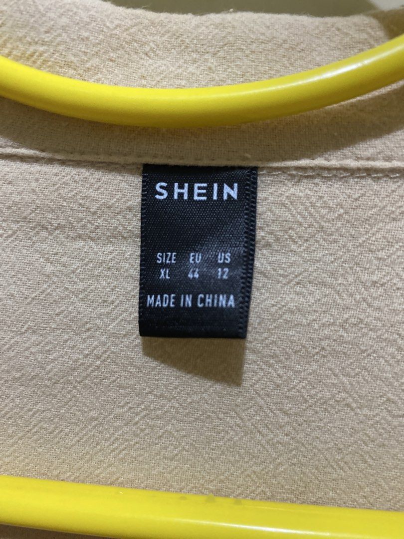SHEIN Beige Cropped Collared Shirt XL (Category: Shirts) located in Pasig City. Submitted by alaineeeee (Listing ID 1462770755, Image 2). Description: - Beige cropped shirt from SHEIN - Features a collared neckline and button-up front - Short sleeves - Size XL - Ideal for casual wear.
