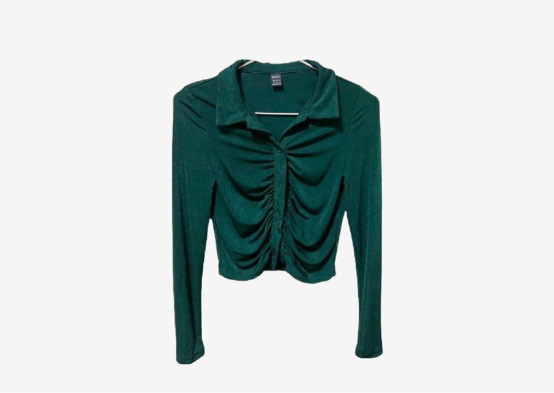 SHEIN Green Ruched Collared Long Sleeve Shirt (Category: Longsleeves) located in Manila. Submitted by purpleeeshop (Listing ID 1462709678, Image 1). Description: - Stylish green collared shirt - Features ruched detailing down the front - Button closure for a classic look - Long sleeves for versatile styling - Material has a subtle shimmer - Trendy cropped fit - Easily dressed up or down for any occasion.