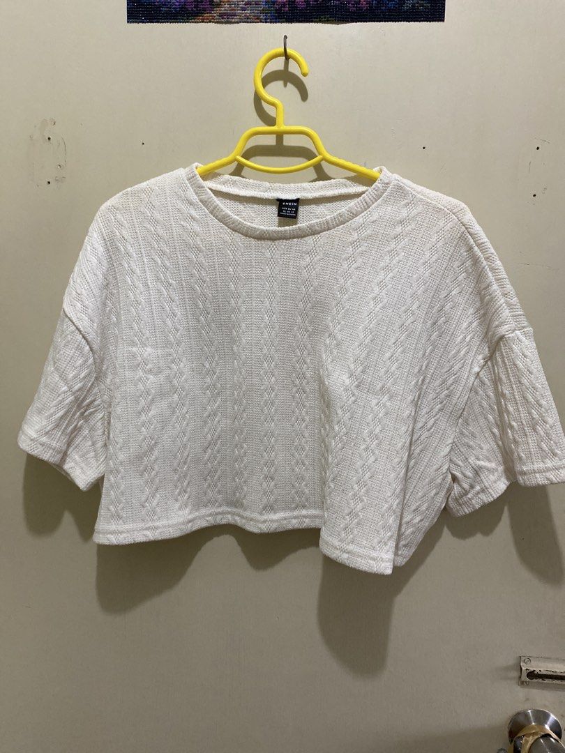 SHEIN White Textured Cropped Top (Category: Blouses) located in Pasig City. Submitted by alaineeeee (Listing ID 1462770418, Image 1). Description: - White textured cropped top from SHEIN - Features a cable knit pattern all over - Short sleeves and relaxed fit for comfort - Stylish and versatile for casual wear - Easily pairs with jeans or skirts.