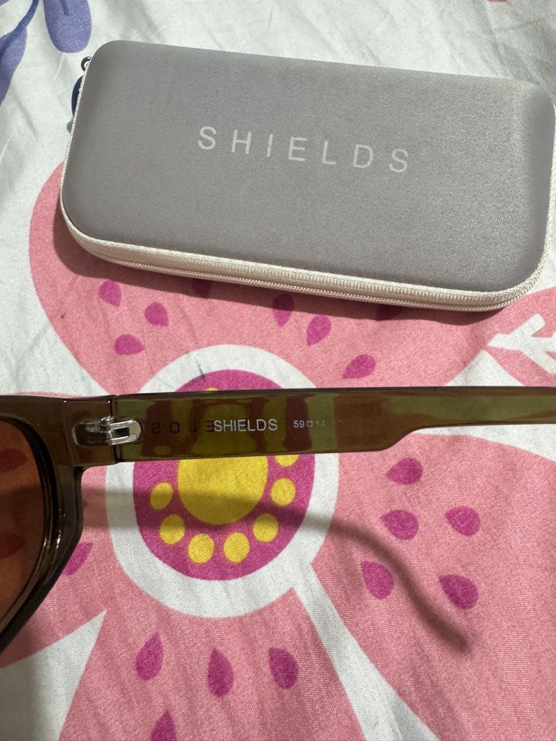 SHIELDS by EO Sunglasses with Case (Category: Sunglasses & Eyewear) located in Manila. Submitted by chie04_875 (Listing ID 1462859832, Image 3). Description: - SHIELDS sunglasses - Includes original hard case - Dark brown/green tortoise shell frame pattern - Gradient brown lenses - Ideal for everyday wear - Case features 'SHIELDS' logo on top.