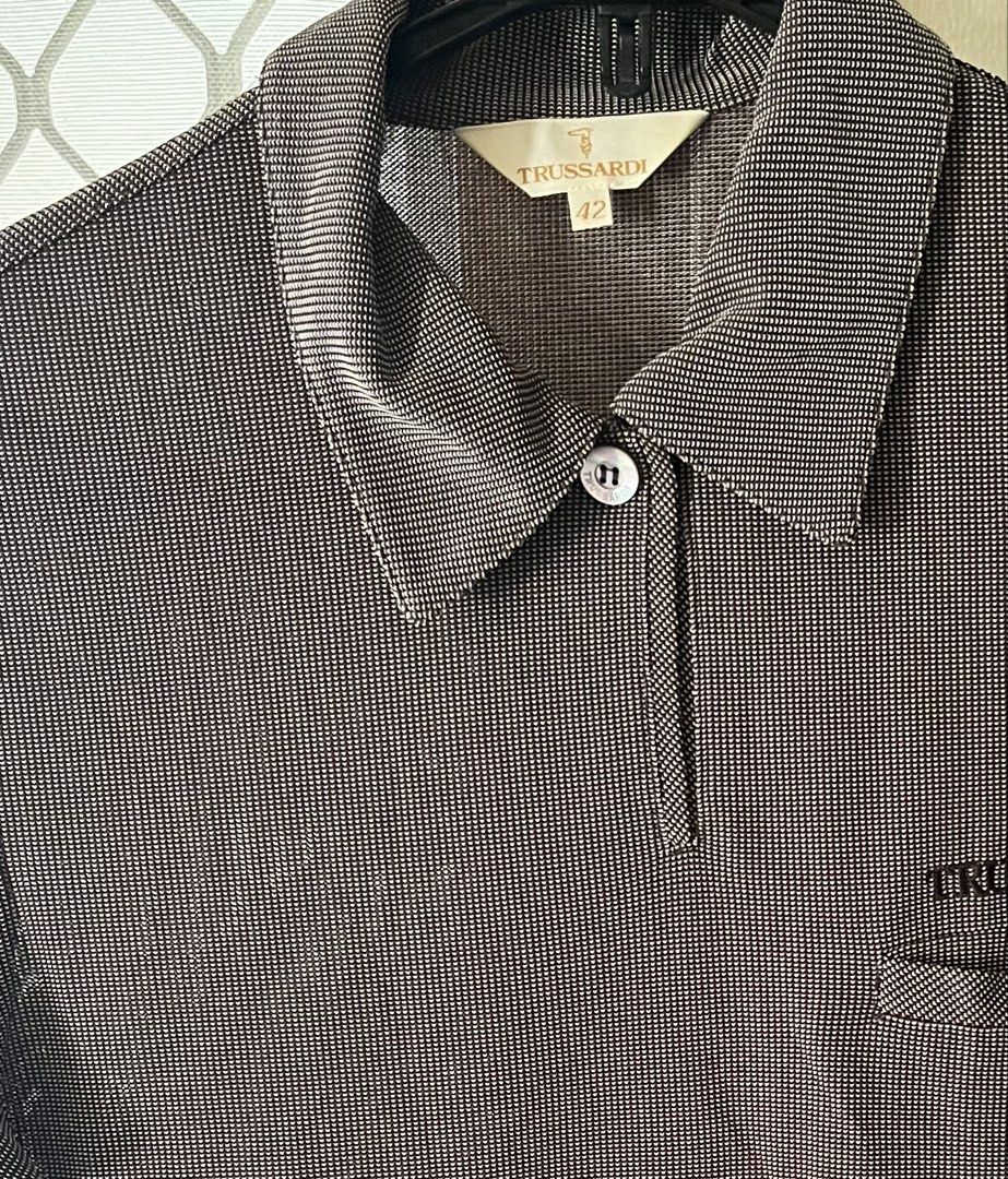 Shirt PoloTrussardi (Category: Others Tops) located in Bacoor. Submitted by ayit. (Listing ID 1462701459, Image 1). Description: - Brand: Trussardi - Type: Polo Shirt - Size: Medium (EU 38 / UK 10 / US 6) - Color/Pattern: Brown checkered - Condition: 4/5 (Good pre-loved condition) - Features: Classic polo collar, chest pocket with embroidered logo -small-med fit Orig personal sf inc .