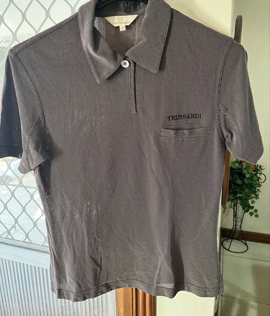 Shirt PoloTrussardi (Category: Others Tops) located in Bacoor. Submitted by ayit. (Listing ID 1462701459, Image 3). Description: - Brand: Trussardi - Type: Polo Shirt - Size: Medium (EU 38 / UK 10 / US 6) - Color/Pattern: Brown checkered - Condition: 4/5 (Good pre-loved condition) - Features: Classic polo collar, chest pocket with embroidered logo -small-med fit Orig personal sf inc .