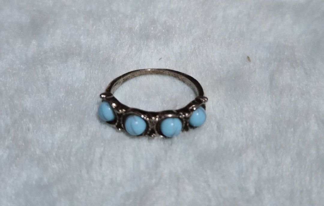Silver Ring with Turquoise Stones Size 6/7 (Category: Rings) located in Mandaue City. Submitted by chuchi152615 (Listing ID 1462809184, Image 1). Description: - Classic silver band ring - Features five round, light blue turquoise stones - Band has decorative detailing - Timeless design, suitable for everyday wear or special occasions.