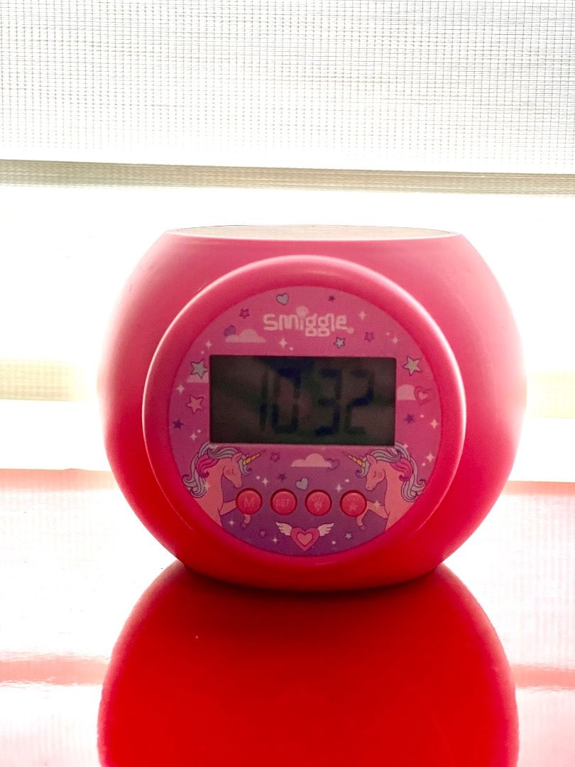 Smiggle Pink Unicorn Alarm Clock (Category: Clocks) located in Marikina City. Submitted by bezz_bezzy (Listing ID 1462806497, Image 2). Description: - Adorable pink Smiggle alarm clock - Features a charming unicorn and star design - Clear digital display for easy time reading - Ideal addition to any child's bedroom - Simple buttons for setting time and alarm.