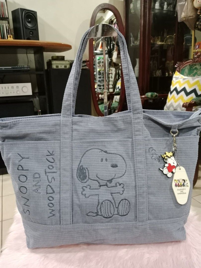 Snoopy Corduroy Tote Bag (Category: Tote Bags) located in Pasig City. Submitted by janalopez904 (Listing ID 1462864212, Image 3). Description: - Adorable pink corduroy tote bag featuring a Snoopy design. - Multiple convenient pockets on the front for easy access. - Includes a long strap for comfortable shoulder or crossbody wear. - Ideal for everyday use, offering ample space for your essentials..