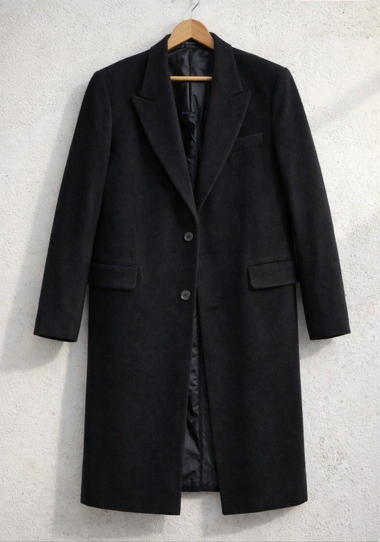 S.T. DUPONT PARIS Wool Overcoat (Category: Coats, Jackets and Outerwear) located in Baguio. Submitted by luxeloomarchive (Listing ID 1462832995, Image 1). Description: S.T. DUPONT PARIS Wool Overcoat ​Description: Classic black single-breasted overcoat from French luxury house S.T. Dupont Paris. Premium 100% wool build featuring notch lapels, a two-button front, flap pockets, and a full satin lining. Clean, structured, and in pristine condition w
